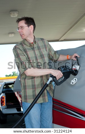Pumping Gas Into a Boat - a man is pumping gas into his boat and looking at the gas pump with an expression of disbelief.