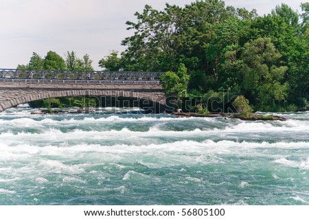 Pedestrian bridge to Goat Island at Niagara Falls State Park in New York, USA.  The bridge crosses the portion of the Niagara river that spills over the American Falls.