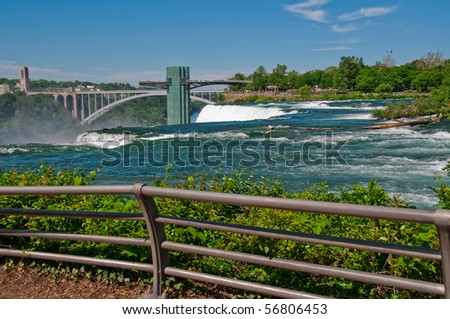 The viewing platform at Niagara Falls, State Park, the oldest state park in the United States.  The water is the Niagara River falling over the American Falls.