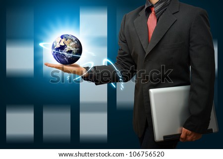 Business man Hold the Digital world on hand : Elements of this image furnished by NASA