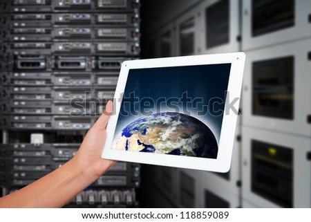 Monitoring the sytem from tablet in data center room : Elements of this image furnished by NASA