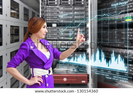 Programmer in data center room with monitor graph