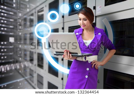 Programmer in data center room with laptop