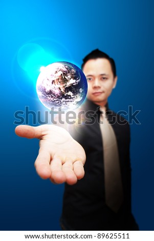 Asia Business man Hold the shining Earth on the hand