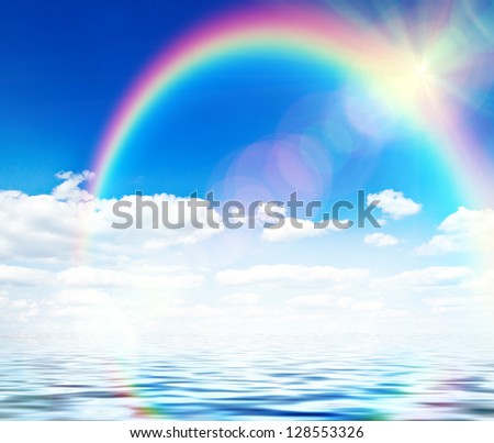 Blue sky background with rainbow and reflection in water