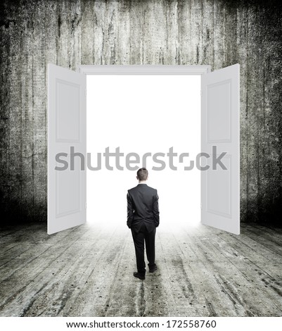 Conceptual image of white opened door with small businessman. Perspective. Future