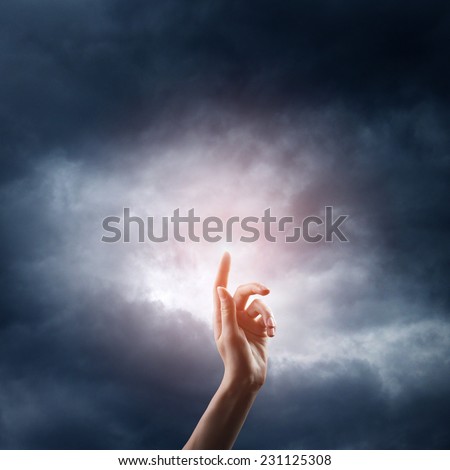 religion concept. finger touching the magic sky