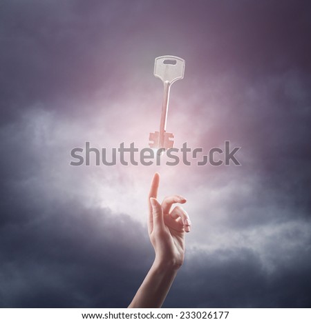 religion concept. finger touching the magic sky with a key