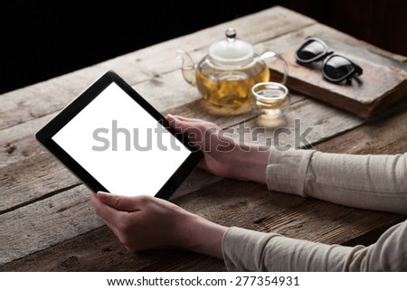 woman shows screen of digital tablet in her hands