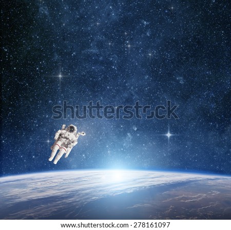 Astronaut in outer space against the  planet earth. Elements of this image furnished by NASA.