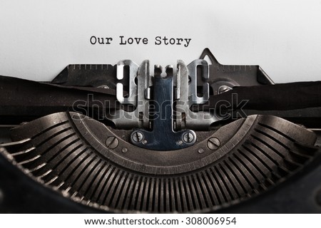 Our love story slogan written by a typewriter on a sheet of a paper