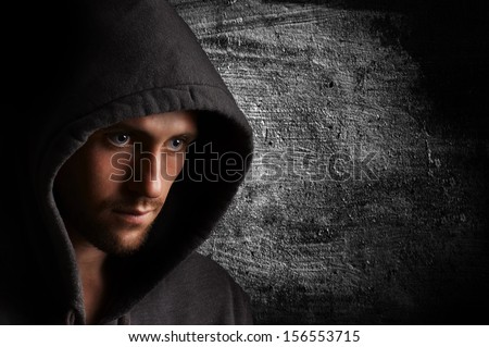 Portrait of a young angry man in the hood