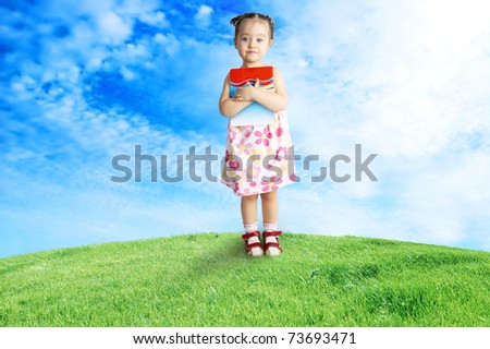 The happy child having control over the book,outdoor