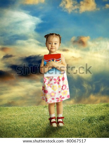 The happy child having control over the book,outdoor