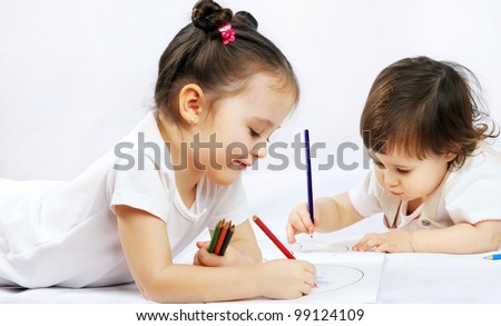 portrait of a two happy pretty girls with a pencils