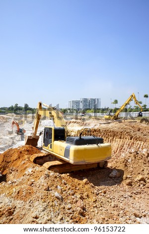 Heavy excavator loader at soil moving works in construction site.