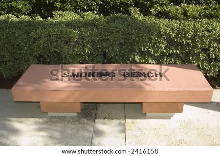 smoking area outside modern office building a concrete bench with the sign \