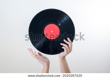 Similar – Image, Stock Photo Woman holding vinyl record. Music passion. Listening to music from analog record. Playing music from analog disk. Enjoying music from old collection. Retro and vintage. Stereo audio. Analog sound