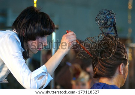 DNEPROPETROVSK, UKRAINE - MARCH 22: Stylist and his model prepar for the Championship on hairdressing, nail aesthetics and make YOUNG TALENTS OF UKRAINE on Mach 22, 2007 in Dnepropetrovsk, Ukraine