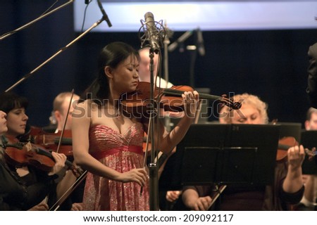 DNIPROPETROVSK, UKRAINE - JUNE 23: Famous Violinist Qian Zhou and Academic Symphony Orchestra perform at the State Russian Drama Theatre on June 23, 2014 in Dnipropetrovsk, Ukraine
