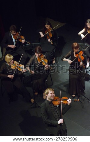DNIPROPETROVSK, UKRAINE - MAY 14: Famous violinist Ostap Shutko and members of the Symphony Orchestra perform at the State Russian Drama Theatre on May 14, 2015 in Dnipropetrovsk, Ukraine