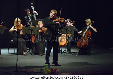 DNIPROPETROVSK, UKRAINE - MAY 14: Famous violinist Ostap Shutko and members of the Symphony Orchestra perform at the State Russian Drama Theatre on May 14, 2015 in Dnipropetrovsk, Ukraine