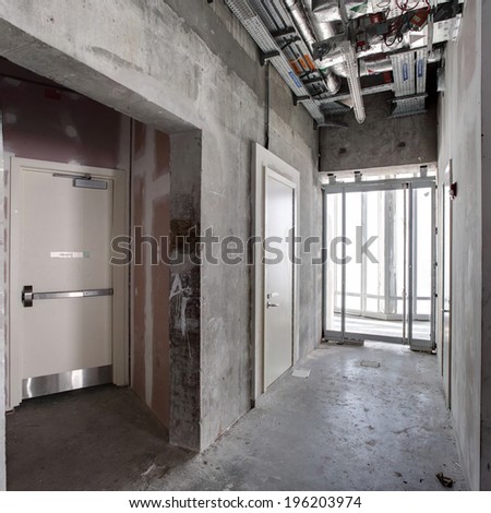 concrete interior of unfinished apartment passage in Dubai.