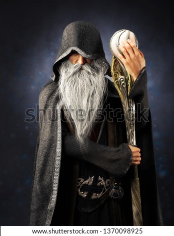 Evil Warlock old hooded wizard posing with staff on a blue gradient background. 3d rendering Сток-фото © 