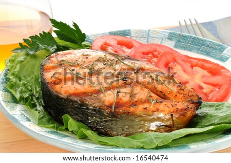 Salmon steak grilled to perfection with fresh vegetables.