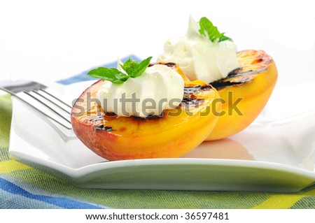 Delicious grilled peaches served with whipped cream.