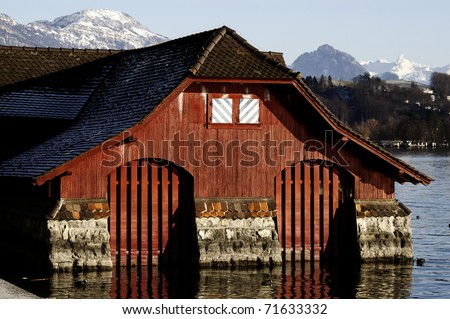 Old wood and stone lake house with two boat garages. Luzern lake with Alps in behind/Lake house/Lake house
