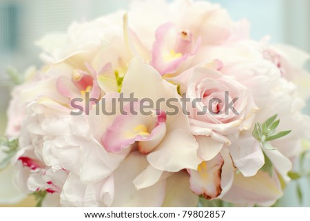 pretty wedding bouquet of roses orchids and greenery