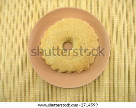 Beautiful sugar fruitcake and a plate on a bamboo napkin