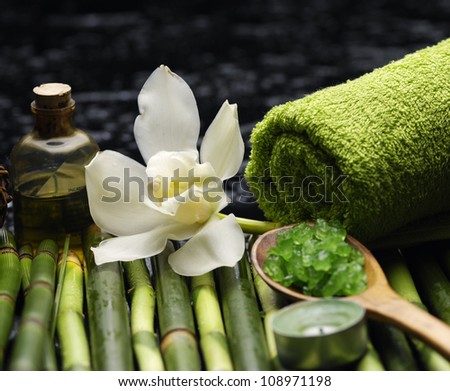 gardenia and Green salt in spoon with massage oil and thin bamboo with towel grove on mat