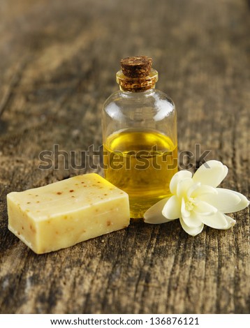 White Gardenia Blossom with spa oil in glass  and soap on driftwood