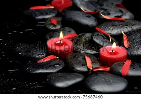 Spa Stones and red petals with two red candle