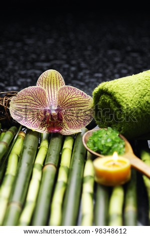 Spa and wellness-green towels, salt and salt on spoon, orchid