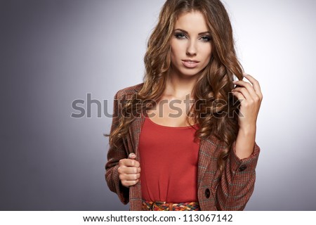 Beautiful high fashion model in autumn clothes posing
