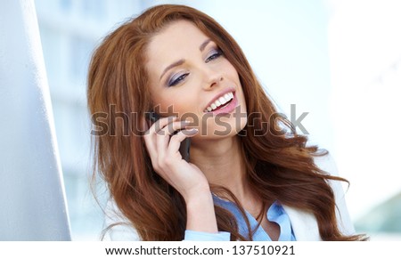 A beautiful young real estate agent woman on the phone