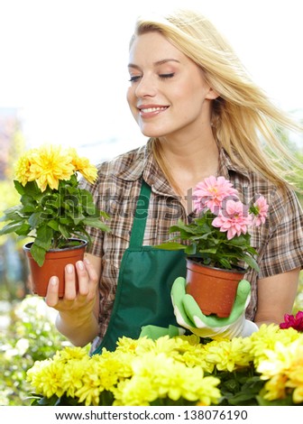 Woman holding a flower box while smiling