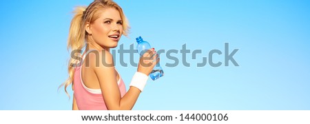 Sporty fitness woman outdoor workout. Young runner woman smiling happy resting after jogging training