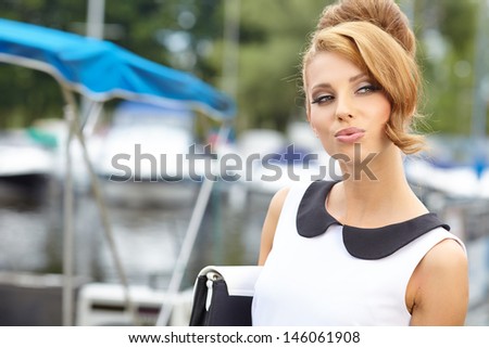 attractive fashion girl on the dock with boat