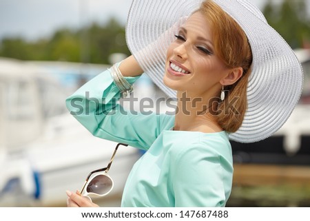 Beautiful young woman in hat summer outdoors