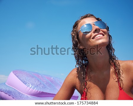 Young perfect woman on an air mattress in the sea