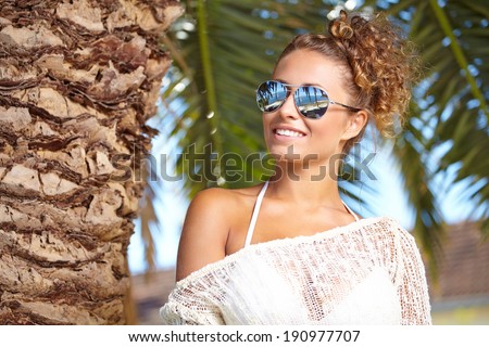 sexy brunette with sunglasses smiling