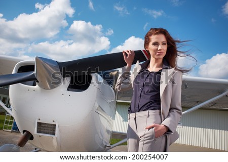 Female pilot preparing for a flight in a light aircraft