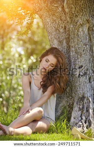 Beautiful woman under an olive tree