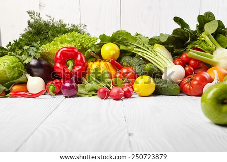 frame with fresh organic vegetables and fruits on wooden background