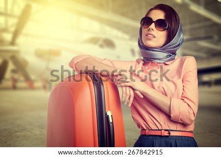 Fashionable woman at the airport on the plane background