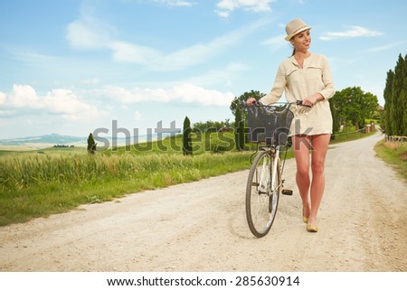 Beautiful vintage girl next to bike, summer Italy time
